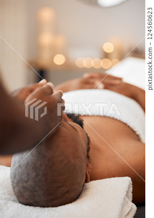 Black man, head massage or relax spa in relax hotel, wellness salon or luxury resort for self care, mental health or peace. Massage therapist, hands and zen aromatherapy for healthy stress management 124560623