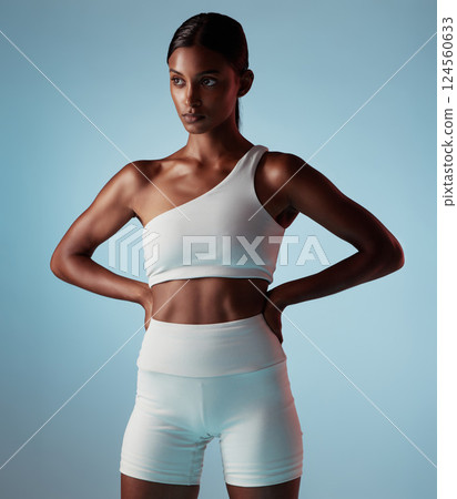 Fitness, muscle and body, woman and exercise training, health and sport motivation with blue studio background. Indian person with energy, tone and workout with wellness and healthy active lifestyle. 124560633