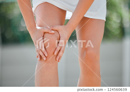 Knee pain, tennis and sports with woman and injury on court with muscle, emergency and sprain. Fitness, workout and health with girl tennis player in outdoor with accident, inflammation and bruise 124560639