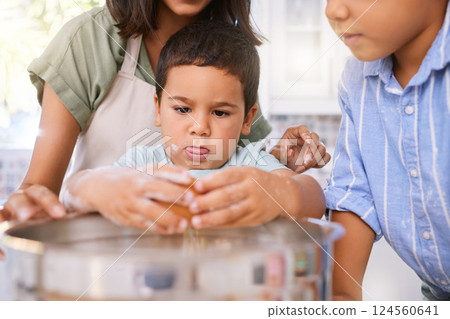 Family, cooking and child learning about baking with eggs in home kitchen with mom teaching kid to bake. Boy, woman and sibling together while helping to cook a meal, cake or food for quality time Family, cooking and child learning about baking with eggs in home kitchen with mom teaching kid to bake. Boy, woman and sibling together while helping to cook a meal, cake or food for quality time 124560641