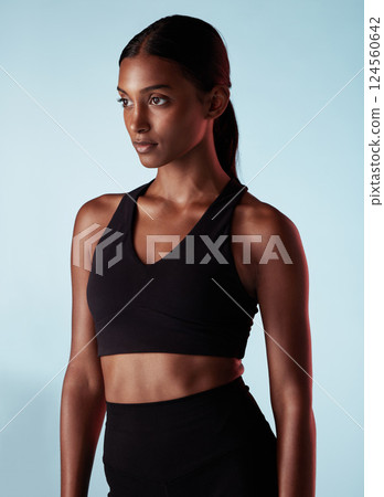 Fitness, health and sports woman in studio for balance, form and motivation. Workout, health and beauty, athlete with goals and vision on blue background, beautiful healthy girl from India in profile Fitness, health and sports woman in studio for balance, form and motivation. Workout, health and beauty, athlete with goals and vision on blue background, beautiful healthy girl from India in profile 124560642