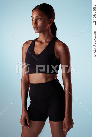 Fitness, training and a woman serious about health on blue studio background. Thinking, focus and concentration on exercise and motivation to workout with sport model with healthy, fit and slim body Fitness, training and a woman serious about health on blue studio background. Thinking, focus and concentration on exercise and motivation to workout with sport model with healthy, fit and slim body 124560682
