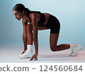 Start position, runner and fitness woman in studio ready for marathon, exercise or cardio workout. Motivation, run and athlete or model from India doing sports training isolated by a blue background. 124560684