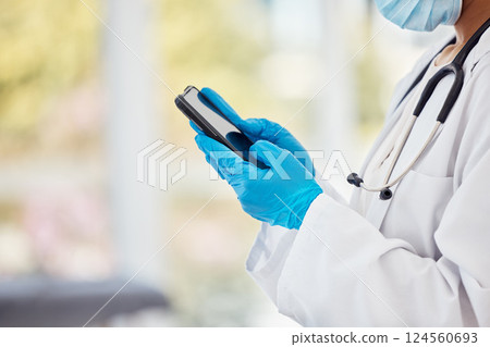 Phone, covid and healthcare with the hands of doctor in gloves using technology for communication in a hospital. Smartphone, insurance or medical with a health professional networking in a clinic Phone, covid and healthcare with the hands of doctor in gloves using technology for communication in a hospital. Smartphone, insurance or medical with a health professional networking in a clinic 124560693