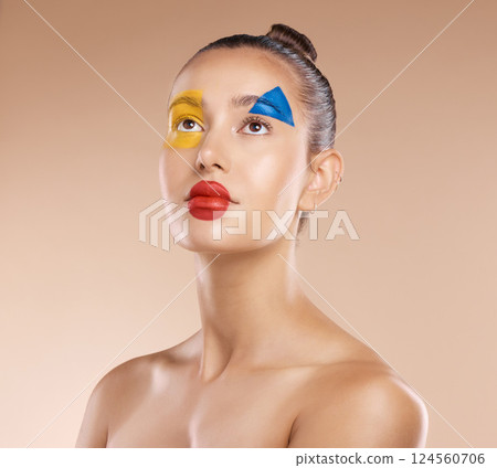 Makeup, clown and young woman with facial art, natural beauty and wellness with brown studio background. Artist, female and girl being creative, with pride and confident with cosmetics or face paint. 124560706