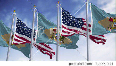 Delaware and US flags waving together in the sky, symbol of American unity Delaware and US flags waving together in the sky, symbol of American unity 124560741