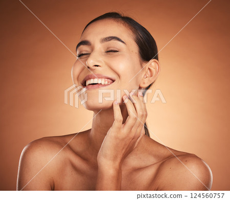 Woman, beauty and smile for skincare, cosmetics or makeup of model in happiness against a studio background. Happy female smiling for moisturizer, facial or care in soft perfect skin treatment 124560757