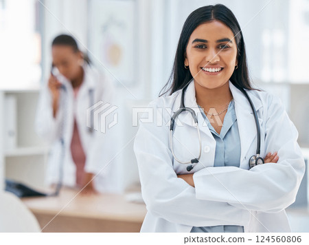 Indian woman, doctor and arms crossed in hospital with trust, wellness goals or healthcare motivation. Portrait, smile or happy medical worker, life insurance employee or friendly consulting surgeon Indian woman, doctor and arms crossed in hospital with trust, wellness goals or healthcare motivation. Portrait, smile or happy medical worker, life insurance employee or friendly consulting surgeon 124560806