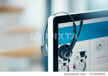 Headphones, call center and computer, screen and empty office. Contact us, customer service or crm, technology and pc, headset and helpdesk for hotline assistance, support or equipment in workplace 124560902
