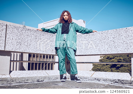 Fashion, stylish and woman in the city with freedom, style and designer clothes in Singapore. Creative, young and portrait of a girl with urban, trendy and street clothing against blue sky in summer 124560921
