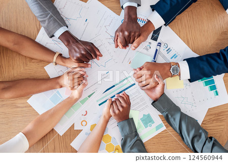 Business people, reports and team holding hands above for meeting, planning or unity at the office. Hand of corporate group in teamwork, strategy or marketing for collaboration, support and trust 124560944