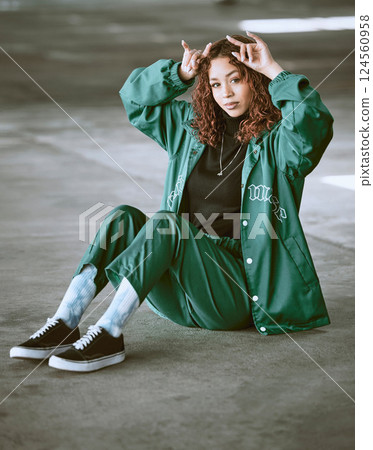 Fashion, style and devil horns with a model black woman making a hand gesture outdoor in the city. Portrait, trendy and edgy with an attractive young female posing to promote contemporary clothes 124560958