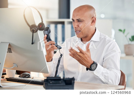 Call center, customer service and arguing with a frustrated man at work in a telemarketing office. Contact us, consulting and angry with an annoyed male working as a sales, support or crm agent 124560968