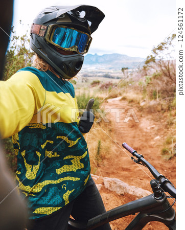 Selfie, cycling and thumbs up by man on bicycle in nature for sport, training and cardio on dirt road. Fitness, influencer and hand thank you sign by cyclist for online, social media and sports blog Selfie, cycling and thumbs up by man on bicycle in nature for sport, training and cardio on dirt road. Fitness, influencer and hand thank you sign by cyclist for online, social media and sports blog 124561172