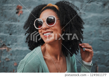 Black woman, fashion and smile with stylish glasses for summer travel against an urban wall background. Happy African American female smiling in satisfaction for fun funky style in the outdoors Black woman, fashion and smile with stylish glasses for summer travel against an urban wall background. Happy African American female smiling in satisfaction for fun funky style in the outdoors 124561177