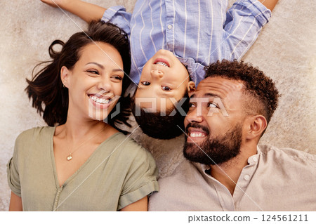 Love, family and floor fun on carpet in a living room with happy, relax and smile parents and boy bonding from above. Black family, face and mother with father and child lying on ground of their home Love, family and floor fun on carpet in a living room with happy, relax and smile parents and boy bonding from above. Black family, face and mother with father and child lying on ground of their home 124561211