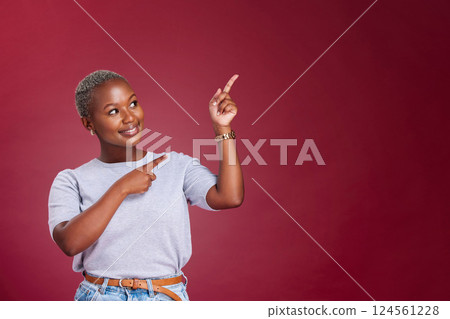 Black woman, mockup and pointing for advertising, marketing or banner against a studio background. Happy African American female point to empty copyspace for sale advertisement text, message or brand 124561228