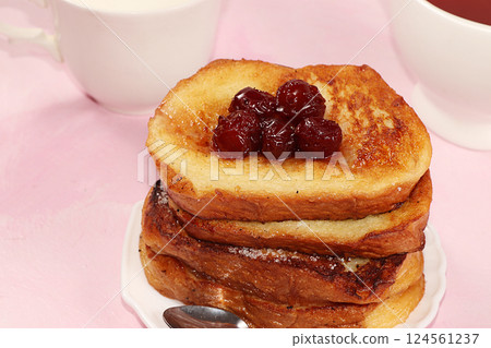 French toasts on a pink table with breadcrumbs. Fried bread with milk and scrambled eggs, concept of a modern bakery. Healthy traditional french breakfast. French toasts on a pink table with breadcrumbs. Fried bread with milk and scrambled eggs, concept of a modern bakery. Healthy traditional french breakfast. 124561237
