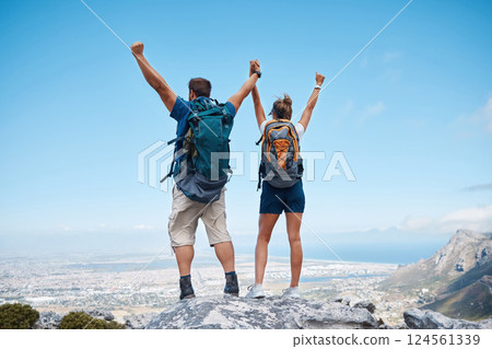 Success, hiking and couple holding hands on mountain for celebration, motivation and freedom on travel in Costa Rica. Back of happy, excited and trekking man and woman celebrate adventure on a cliff 124561339