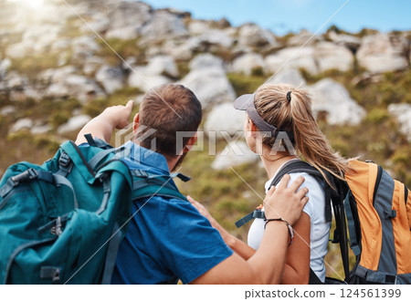 Hiking, couple and mountain in nature with rock, climbing and challenge for fitness, exercise and performance. Hand, man and woman looking up hill, hikers, morning and cardio workout adventure 124561399