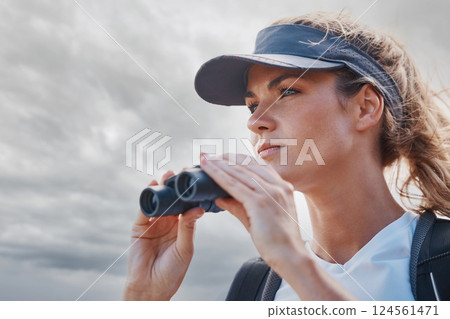 Woman, binoculars and hiking in nature, travel or outdoors vacation, holiday or trip in Canada. Freedom, cloudy sky and female on adventure, sightseeing or trekking and looking with field glasses. 124561471