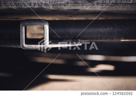 Selective focus on the front end of an empty square hitch receiver on the back end of a vehicle. Selective focus on the front end of an empty square hitch receiver on the back end of a vehicle. 124562092