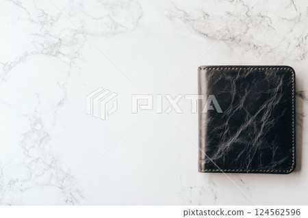 Elegant leather wallet resting on a light marble surface showcasing fine craftsmanship and design 124562596