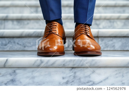 Polished shoes of a businessman ascending marble stairs at a corporate building 124562976