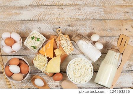 Assorted fresh dairy products, healthy breakfast with ingredients, natural food concept, top view with place for text, diet food, rustic table, selective focus 124563256