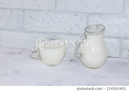 Fresh simple homemade kefir drink on a gray concrete background with copy space. Probiotic cold sour milk drink, the concept of a healthy diet, maintaining a healthy intestinal microflora,diet food, Fresh simple homemade kefir drink on a gray concrete background with copy space. Probiotic cold sour milk drink, the concept of a healthy diet, maintaining a healthy intestinal microflora,diet food, 124563402