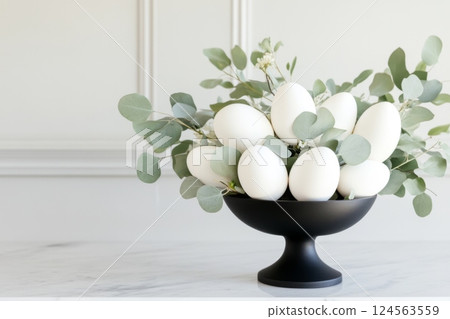 Minimalist Easter centerpiece featuring white eggs and eucalyptus leaves creates a serene holiday decoration with Easter eggs 124563559