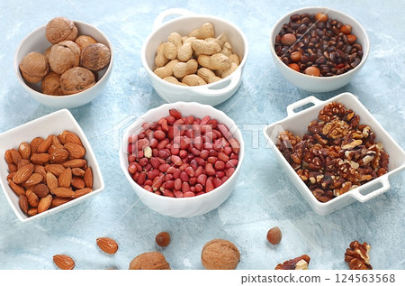 Assortment of different nuts, healthy natural food concept, almonds, pecans, pistachios, cashews, walnuts and pine nuts, high-calorie food with vegetable protein and vitamins, 124563568