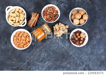 Assortment of different nuts, the concept of healthy natural food, almonds, pecans, pistachios, cashews, walnuts and pine nuts, high-calorie food with vegetable protein and vitamins, the basis of diet 124563573