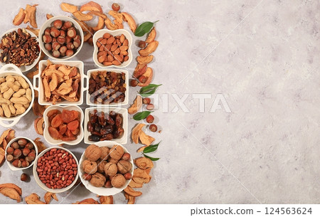 Assortment of various nuts and dried fruits, healthy natural food concept, almonds, nuts, pecans, pistachios, cashews, walnuts and pine nuts, apples, raisins, dried apricots, food with vegetable Assortment of various nuts and dried fruits, healthy natural food concept, almonds, nuts, pecans, pistachios, cashews, walnuts and pine nuts, apples, raisins, dried apricots, food with vegetable 124563624