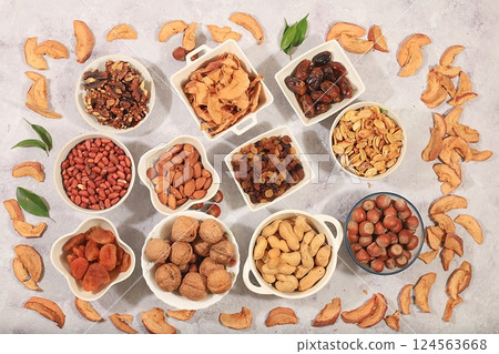 Assortment of various nuts and dried fruits, healthy natural food concept, almonds, nuts, pecans, pistachios, cashews, walnuts and pine nuts, apples, raisins, dried apricots, food with vegetable Assortment of various nuts and dried fruits, healthy natural food concept, almonds, nuts, pecans, pistachios, cashews, walnuts and pine nuts, apples, raisins, dried apricots, food with vegetable 124563668