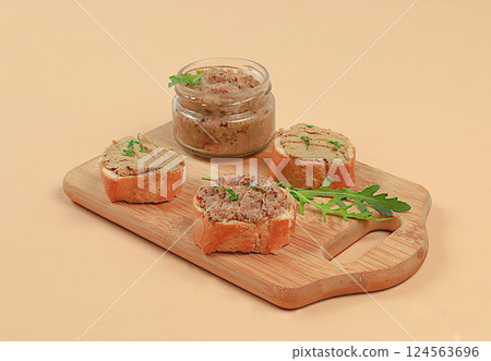 Chicken pate with homemade whole grain bread and herbs on a light table, the concept of a healthy lifestyle and natural nutrition. Healthy breakfast with ingredients, advertising for a cafe, selective 124563696