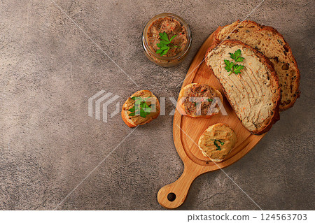 Chicken pate with homemade whole grain bread and herbs on a dark table, the concept of a healthy lifestyle and natural nutrition. Healthy breakfast with ingredients, advertising for a cafe, selective 124563703