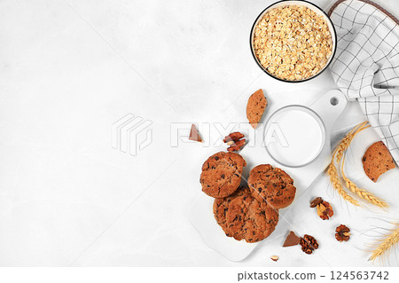 Freshly baked homemade oatmeal cookies with chocolate chips and gluten free nuts with ears on concrete background,modern bakery and grain food concept.Healthy breakfast with ingredients,top Freshly baked homemade oatmeal cookies with chocolate chips and gluten free nuts with ears on concrete background,modern bakery and grain food concept.Healthy breakfast with ingredients,top 124563742
