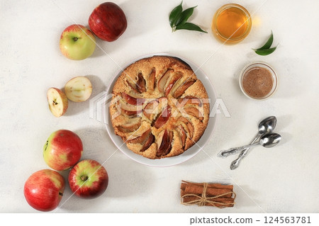 Kitchen background with apple pie, honey, apples, spices, cozy warm concept, hello autumn, hygge style, modern bakery advertisement, selective focus, top view, space for text, Kitchen background with apple pie, honey, apples, spices, cozy warm concept, hello autumn, hygge style, modern bakery advertisement, selective focus, top view, space for text, 124563781