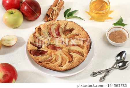 Kitchen background with apple pie, honey, apples, spices, cozy warm concept, hello autumn, hygge style, modern bakery advertisement, selective focus, top view, space for text, 124563783