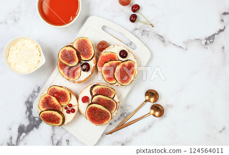 Ricotta,figs and bruschetta with honey on gray marble.Fresh sandwiches and toast with cream cheese,sliced figs,honey and cherries.Healthy breakfast with ingredients,lunch or dessert,diet food Ricotta,figs and bruschetta with honey on gray marble.Fresh sandwiches and toast with cream cheese,sliced figs,honey and cherries.Healthy breakfast with ingredients,lunch or dessert,diet food 124564011