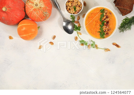 Pumpkin and zucchini cream soup with roasted seeds and toast,traditional autumn vegan food,healthy natural breakfast with place for recipe,advertising for cafe,restaurant,business card,selective focus Pumpkin and zucchini cream soup with roasted seeds and toast,traditional autumn vegan food,healthy natural breakfast with place for recipe,advertising for cafe,restaurant,business card,selective focus 124564077