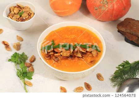 Pumpkin and zucchini cream soup with roasted seeds and toast,traditional autumn vegan food,healthy natural breakfast,advertising for cafe,restaurant,business card,selective focus Pumpkin and zucchini cream soup with roasted seeds and toast,traditional autumn vegan food,healthy natural breakfast,advertising for cafe,restaurant,business card,selective focus 124564078