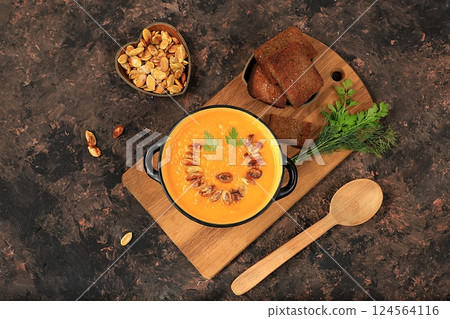 Pumpkin and zucchini cream soup with roasted seeds and toast,traditional autumn vegan food,healthy natural breakfast,advertising for cafe,restaurant,business card,selective focus Pumpkin and zucchini cream soup with roasted seeds and toast,traditional autumn vegan food,healthy natural breakfast,advertising for cafe,restaurant,business card,selective focus 124564116