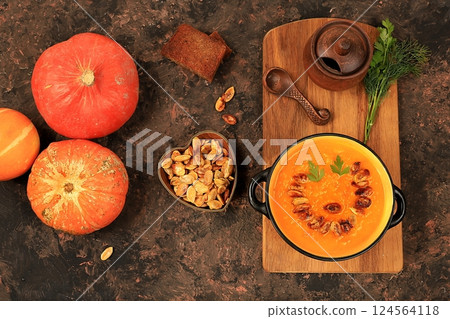 Pumpkin and zucchini cream soup with roasted seeds and toast,traditional autumn vegan food,healthy natural breakfast,advertising for cafe,restaurant,business card,selective focus 124564118