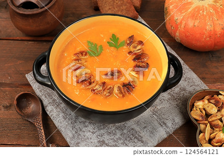Pumpkin and zucchini cream soup with roasted seeds and toast,traditional autumn vegan food,healthy natural breakfast,advertising for cafe,restaurant,business card,selective focus Pumpkin and zucchini cream soup with roasted seeds and toast,traditional autumn vegan food,healthy natural breakfast,advertising for cafe,restaurant,business card,selective focus 124564121
