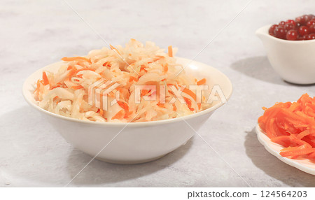 Sauerkraut or pickled cabbage on a light table.Fermented food food background,banner for advertising,healthy food concept,natural products for weight loss,top view,selective focus 124564203