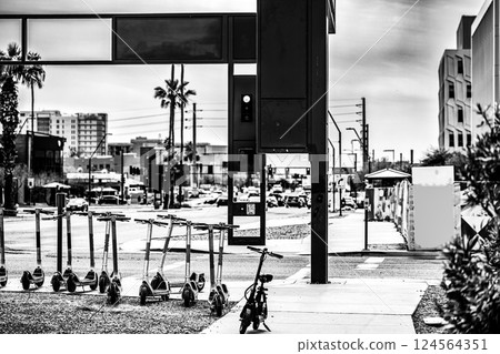 Row of electric scooters in an urban campus street crossroad. Row of electric scooters in an urban campus street crossroad. 124564351