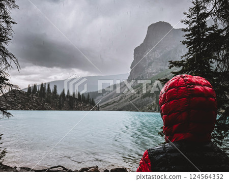 Boy on the shoreline gazing out into Lake Louise, Alberta, Canada in Banff National Park. Boy on the shoreline gazing out into Lake Louise, Alberta, Canada in Banff National Park. 124564352