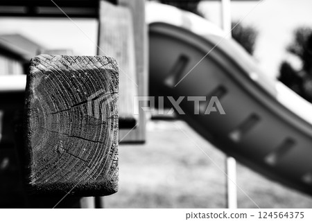 Cracked and weathered end grain wood on an outdoor playset  124564375